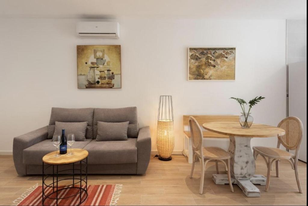 a living room with a couch and a table at Marbella Old Town Apartments by Homing in Marbella