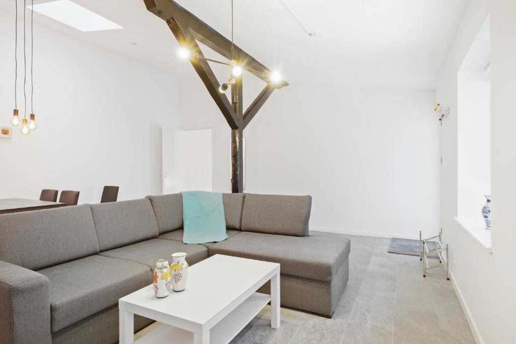 uma sala de estar com um sofá e uma mesa em Come Stay - Charming Oasis in The Heart of Aalborg em Aalborg