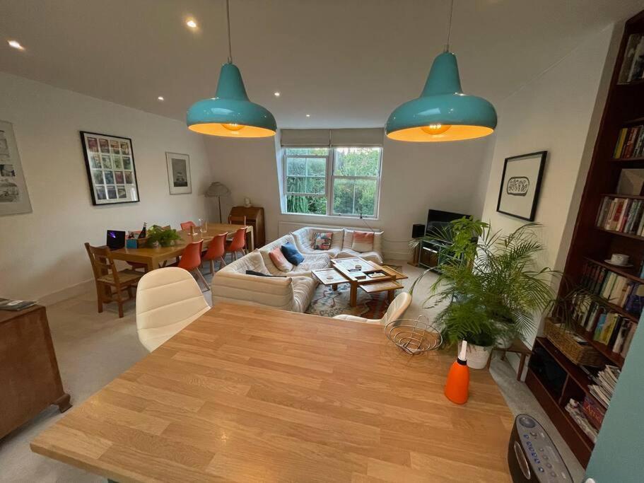 a living room with a table and blue lights at Beautiful 3 Bed in Leafy Hampstead in London
