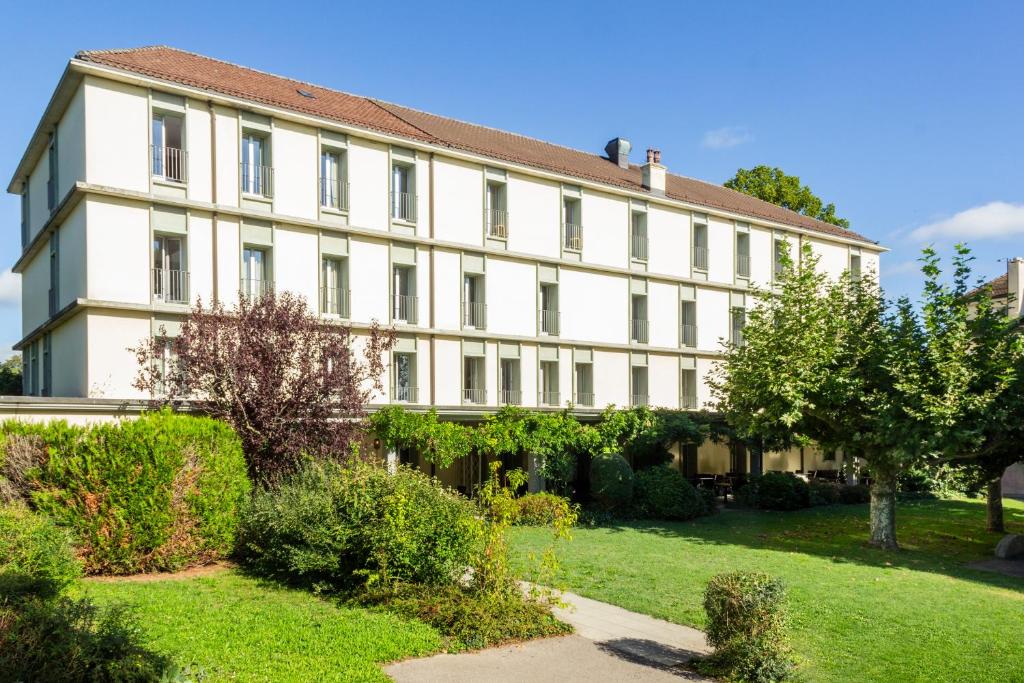 a large white building with a garden in front of it at Hotel La Longeraie in Morges