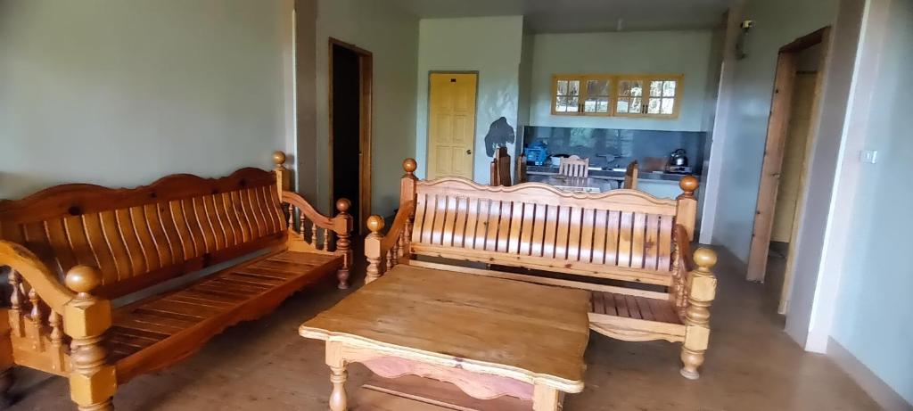 a group of wooden benches in a room at Azaeleas Lodging House in Sagada