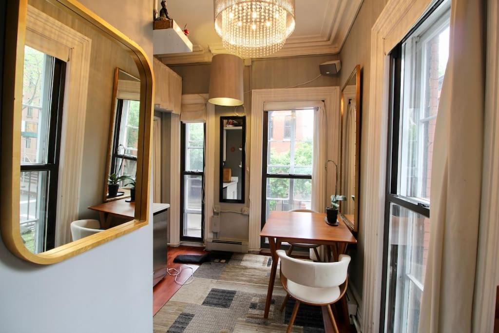 a bathroom with a mirror and a table and chair at The West Village Gem in New York