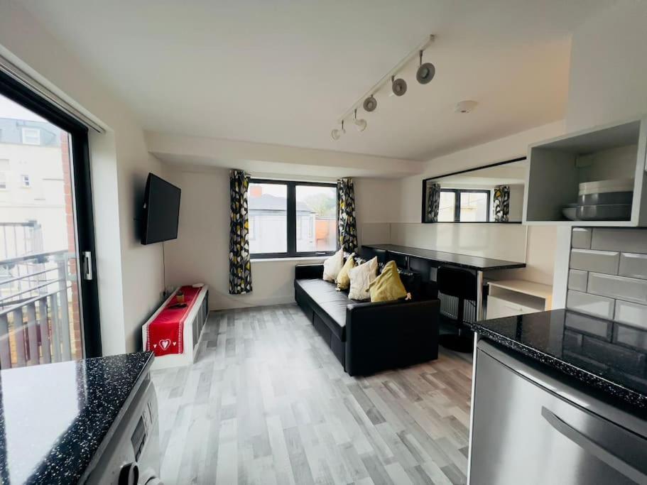 een woonkamer met een bank en een tafel bij Lovely 2 bedroom flat with free parking Flat 5 in Nottingham