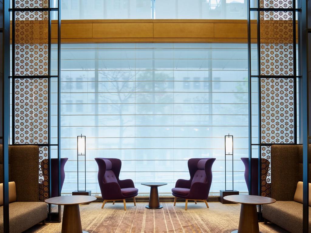 a lobby with chairs and tables and a large window at Hotel The Celestine Tokyo Shiba in Tokyo