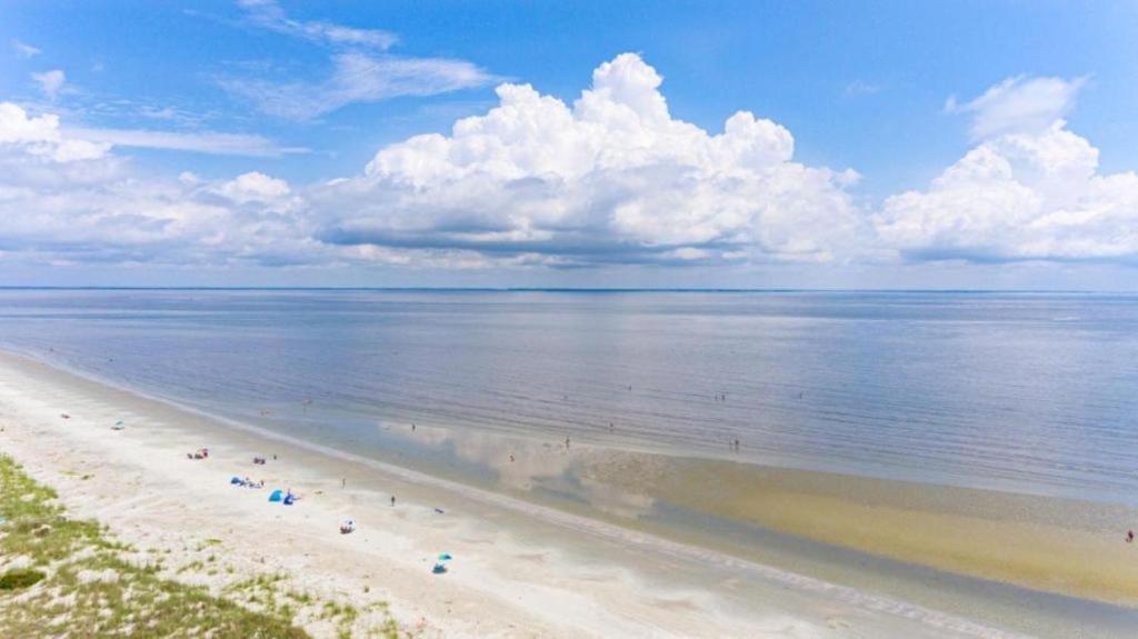 a view of a beach with people on it at Direct Ocean View! M Building Pool and Ocean Views in Harbor Island