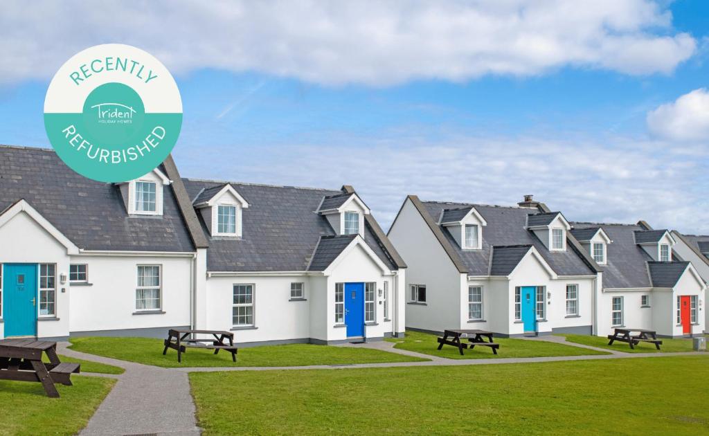 a row of houses with a sign in front at Dingle Holiday Homes (S7) in Dingle