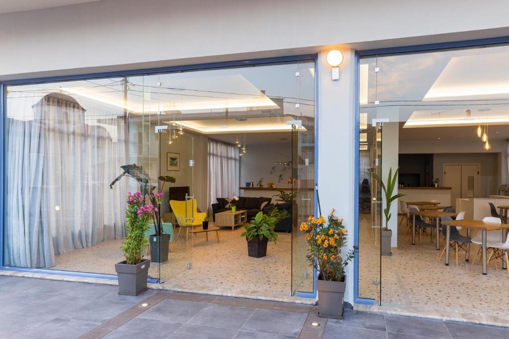 a glass door with potted plants inside of a building at Vivari Acta in Vivari
