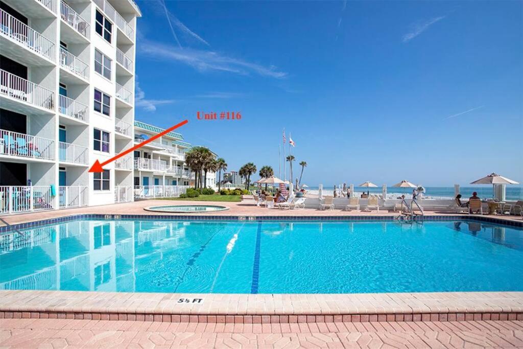 una piscina frente a un hotel en SeaBliss, oceanfront 1st floor cozy condo, en Daytona Beach