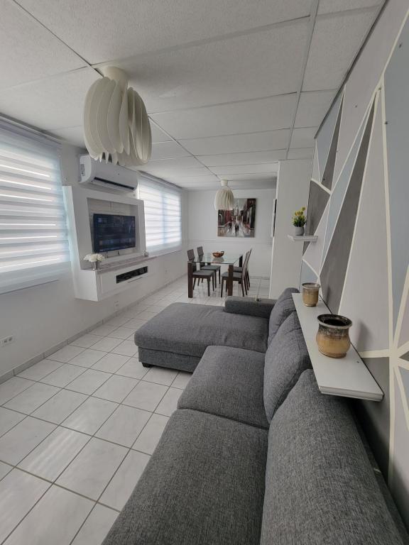 a living room with a couch and a table at MF Vacation Homes Villa 2 in Loiza