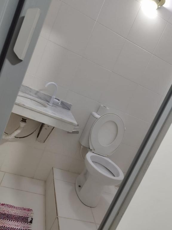 a bathroom with a white toilet in a room at Trairão do Encantado in Jacareí
