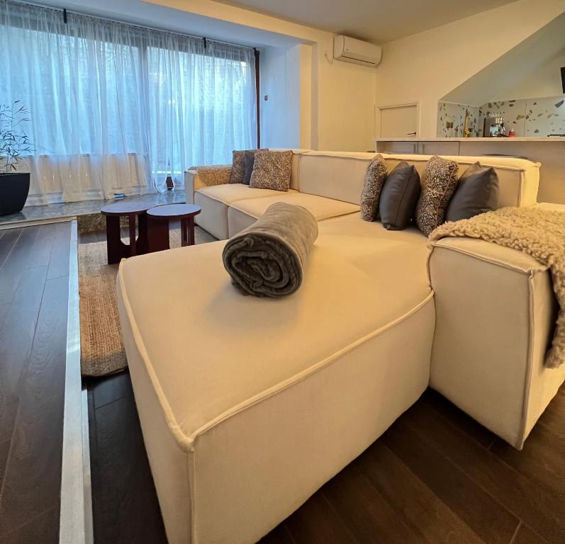 a living room with a large white couch with pillows at Cozy Residence Sv. Duh in Zagreb