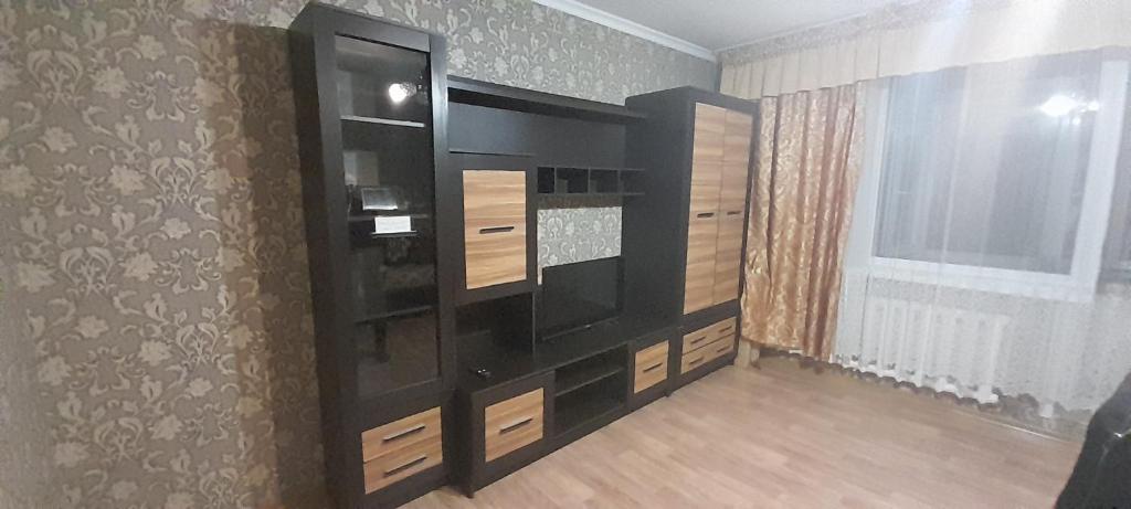 a black cabinet with a television in a room at Semey in Semey