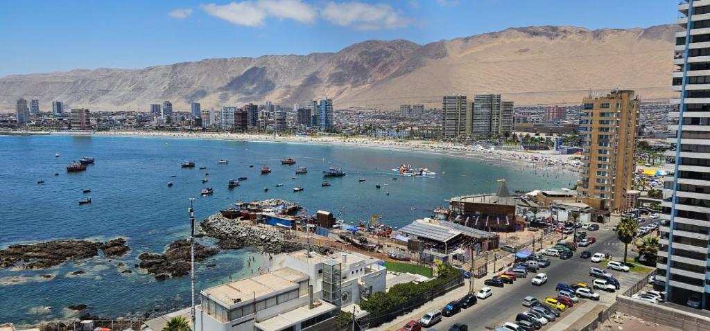 a city with a beach with boats in the water at Nautilus Peninsula Piso 14 (Cerca de Todo) in Iquique