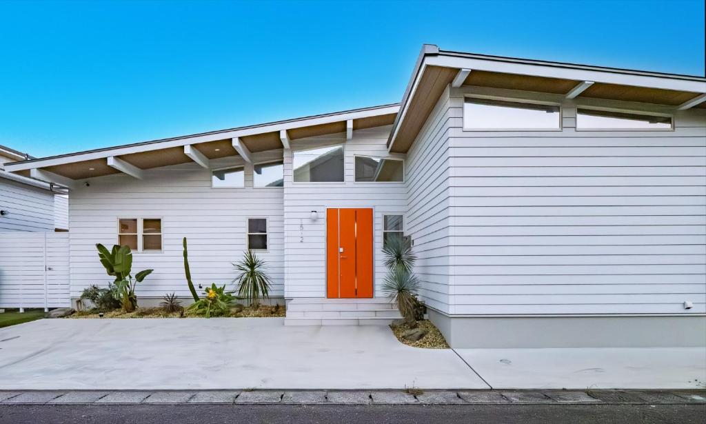 a white house with a red door at MIYAZAKI BASE in aoshima - Vacation STAY 82721v in Miyazaki