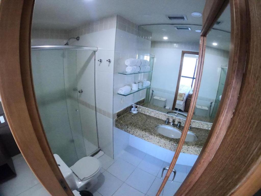 a bathroom with a shower and a toilet and a sink at Tropical Executive Hotel in Manaus