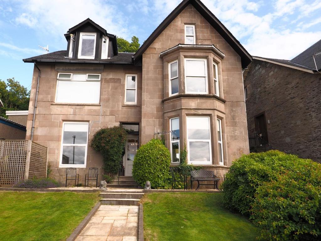 a large brick house with a clock tower on top at 3 Bed in Cove 73939 in Cove