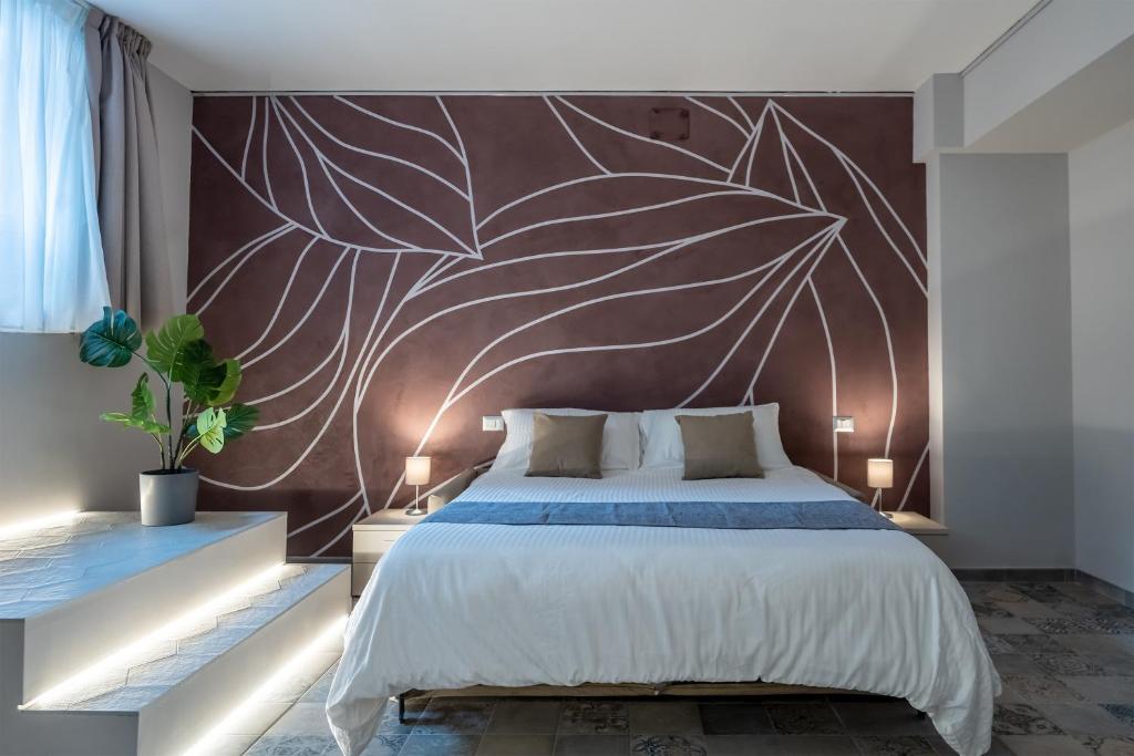 a bedroom with a large bed with a wall mural at [Duomo-Navigli] Vie di Milano - 3 Indipendent Loft in Milan