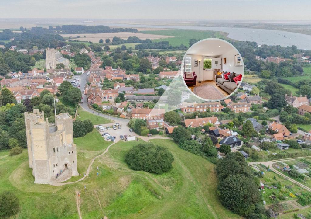 an aerial view of a castle and a house at Bailey Cottage in Orford
