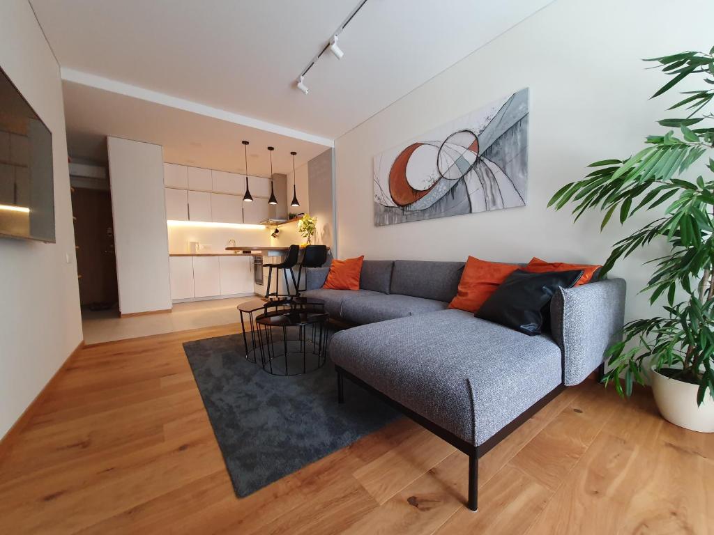 a living room with a couch and a table at Parko rezidencija apartments - SELF CHECK-IN in Panevėžys