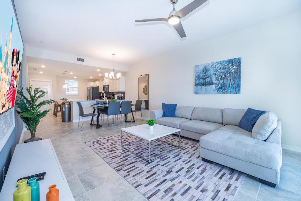 a living room with a couch and a table at 3171-204AZ STOREY LAKE, CONDO 2/2 LAKE VIEW in Kissimmee