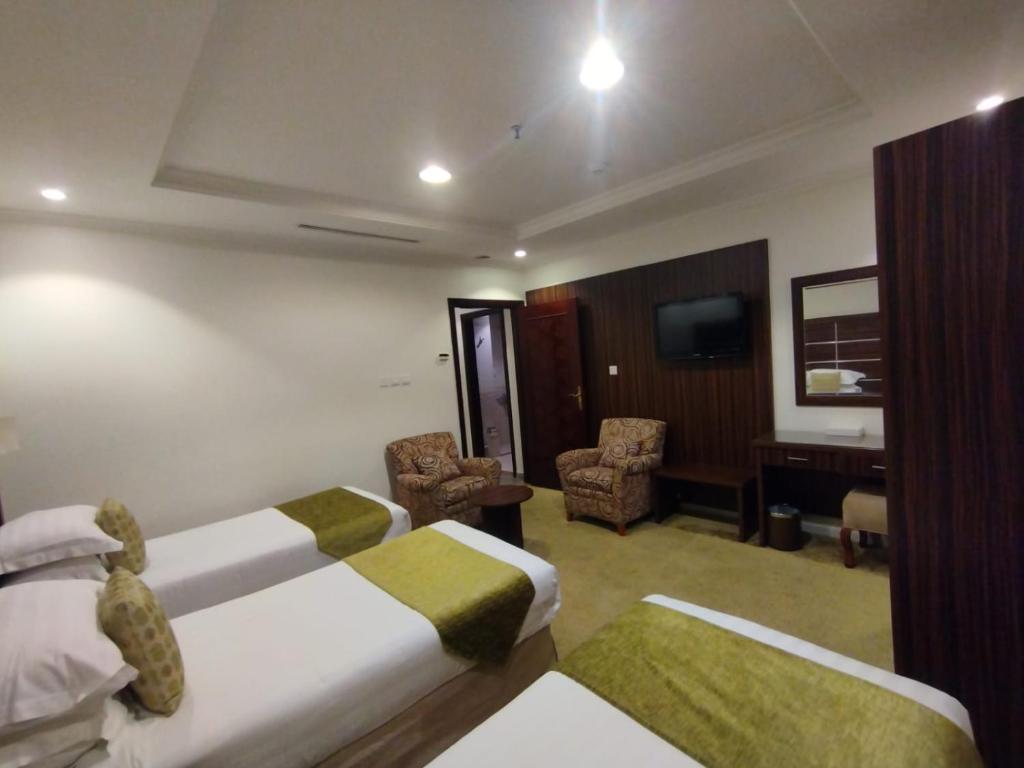 Postel nebo postele na pokoji v ubytování فندق اوتاد المتحدة الماسي awtad elmasi hotel