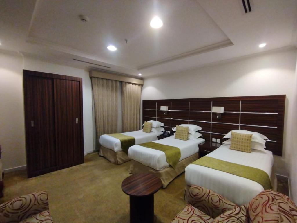 Postel nebo postele na pokoji v ubytování فندق اوتاد المتحدة الماسي awtad elmasi hotel