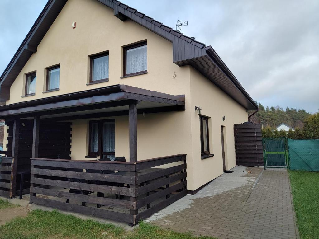 een huis met een zwart dak bij Wakacje nad morzem w Rusinowie in Rusinowo