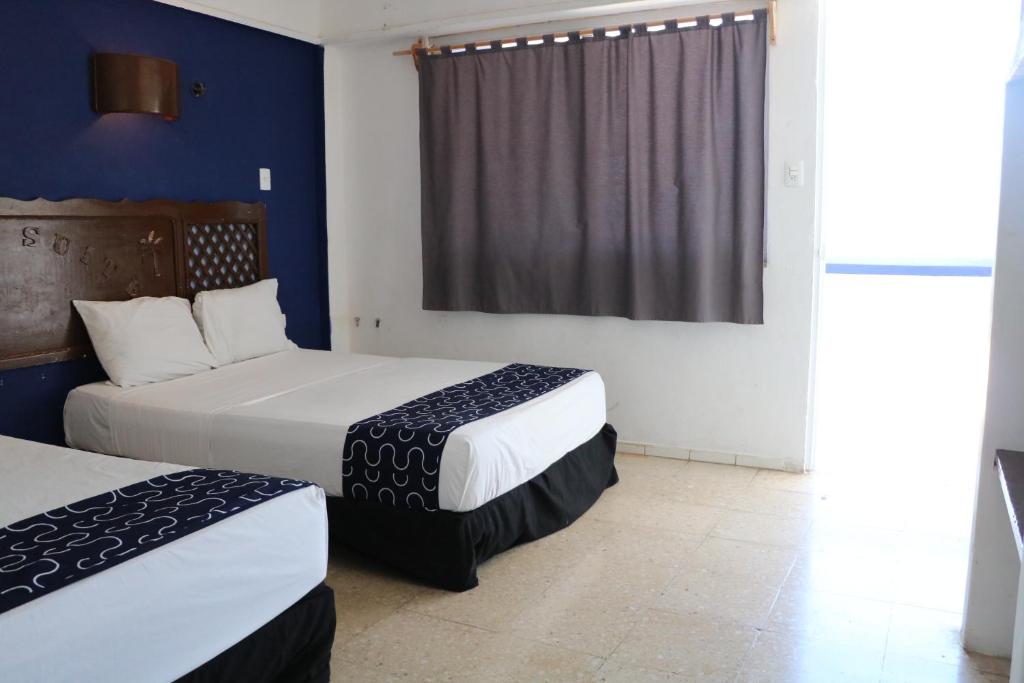 Postel nebo postele na pokoji v ubytování Hotel Tropical