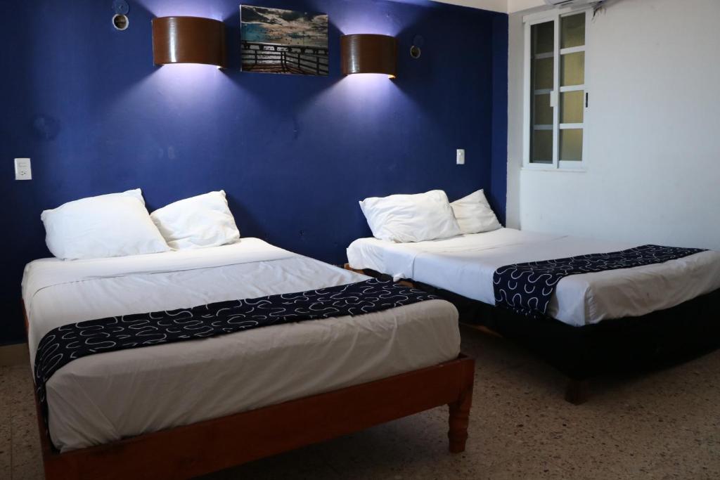 Postel nebo postele na pokoji v ubytování Hotel Tropical