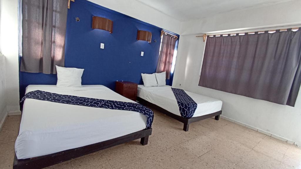 Postel nebo postele na pokoji v ubytování Hotel Tropical