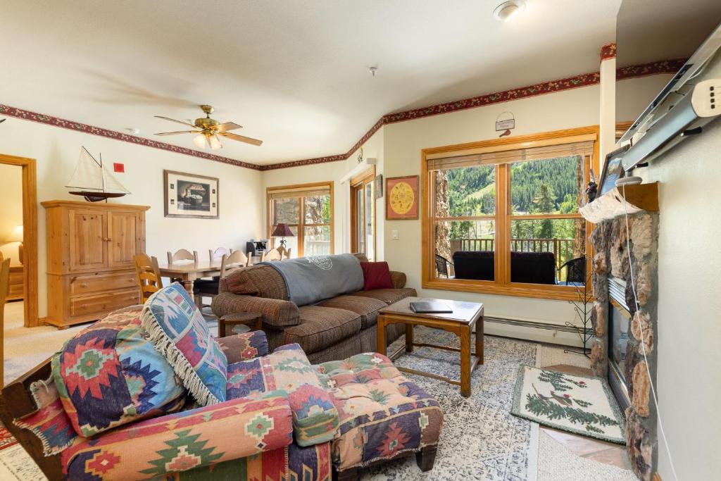 a living room with a couch and a fireplace at 5949 Hidden River Lodge Condo in Keystone