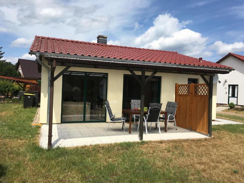 a gazebo with chairs and a table on a patio at Ferienhaus Pirol am Vilzsee in Mirow in Mirow