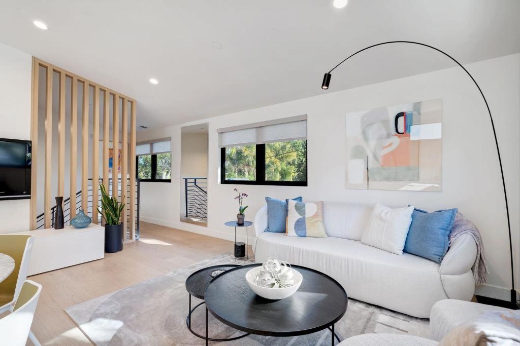 a living room with a white couch and a table at Dazzling Modern Home Close to Downtown Palo Alto and Stanford in Menlo Park