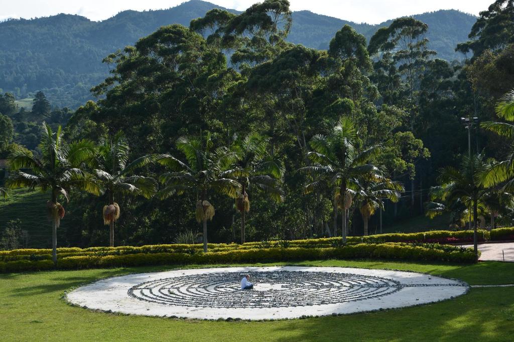 a person is sitting in a circle in a park at Mountains Of Hope in Rionegro