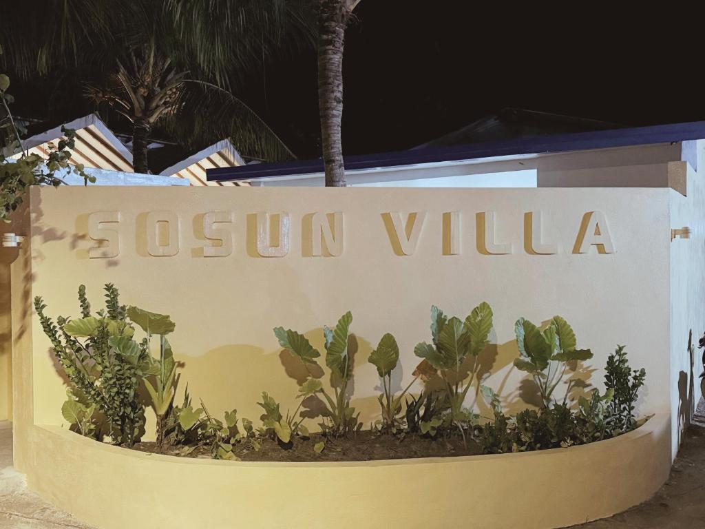 a sign for a resort villa at night at Sosun Villa Thoddoo in Thoddoo