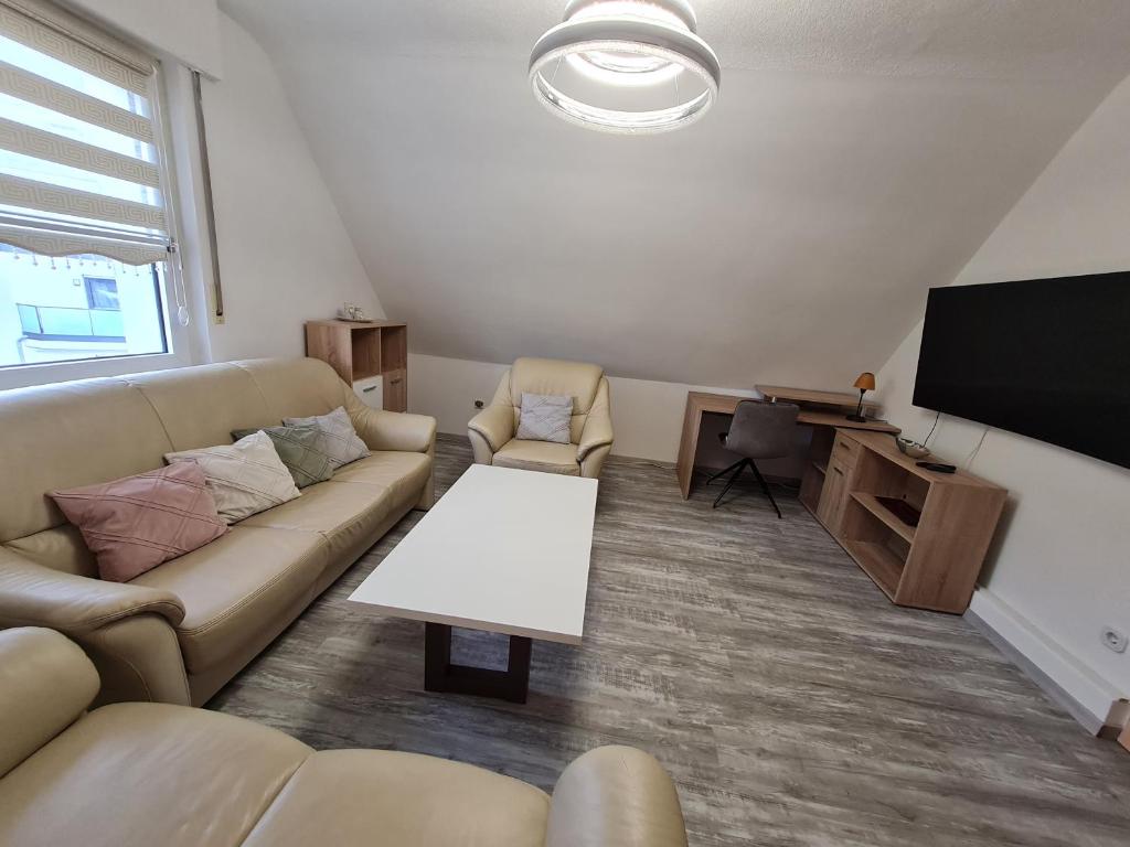 a living room with a couch and a flat screen tv at Im Herzen von Paderborn in Paderborn