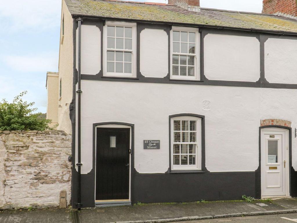 a white house with a black and white facade at 23 Chapel Street in Conwy