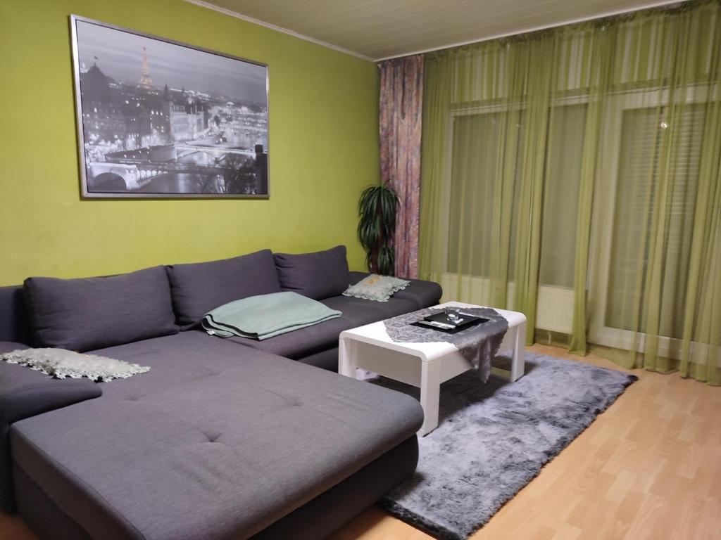 a living room with a couch and a table at Komfortable Ferienwohnung in Flörsheim-Weilbach in Flörsheim