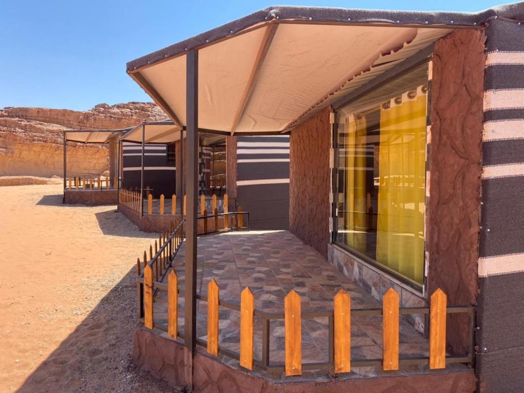 a small building with awning in the desert at Desert Island Camp in Aqaba