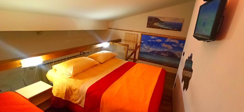 a bedroom with a bed and a flat screen tv at Domus Accomodations in Palermo