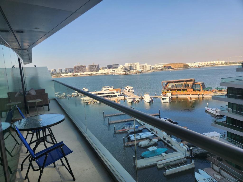 a balcony with a view of a marina with boats at Sea View 1BR Al Raha Beach in Abu Dhabi