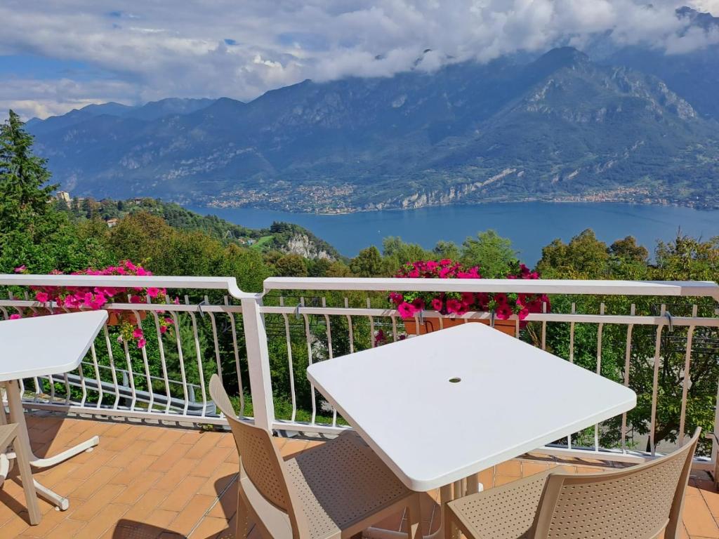 a table and chairs on a balcony with a view of a lake at PROVINCIALE 79 in Magreglio