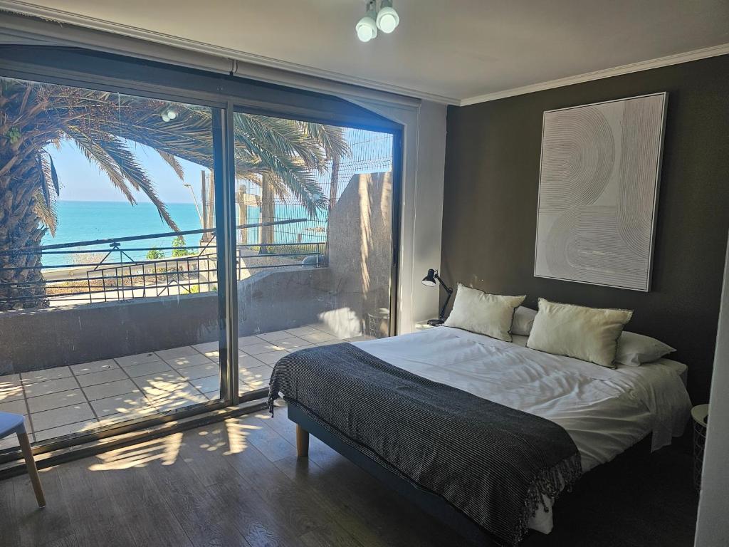 une chambre avec un lit et une vue sur l'océan dans l'établissement Espectacular Bahía Bonita Depto 11, à Concón