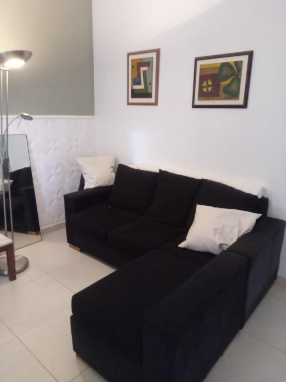 a black couch sitting in a living room at DAS THOMY II in Córdoba