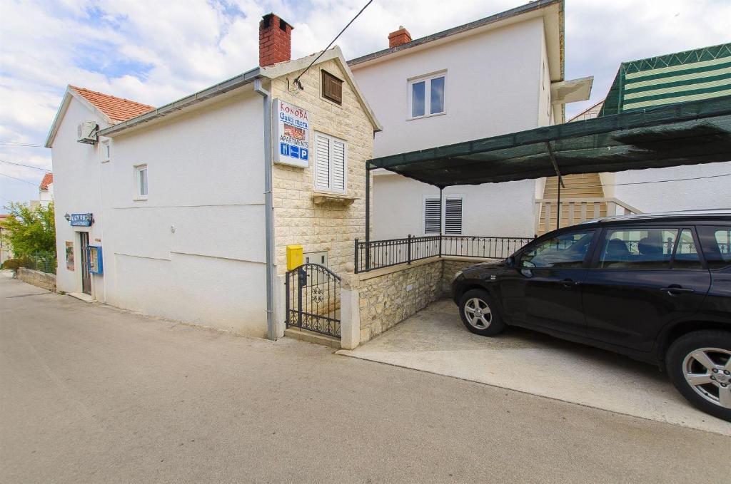 a black car parked in front of a building at House Andelka in Supetar