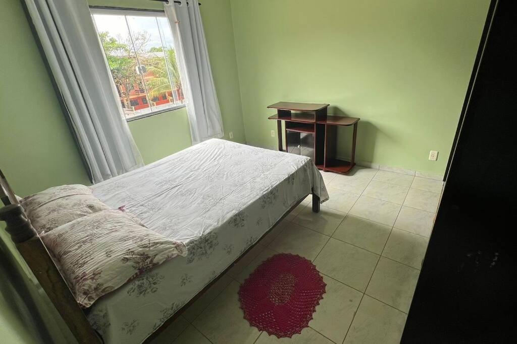 Tempat tidur dalam kamar di Apartamento em Setiba
