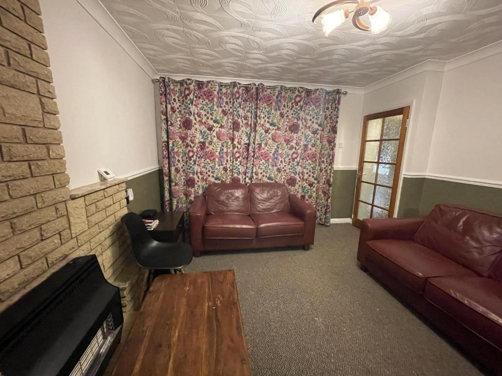 a living room with a couch and a chair at Inviting 2-Bed House in Birmingham in Birmingham