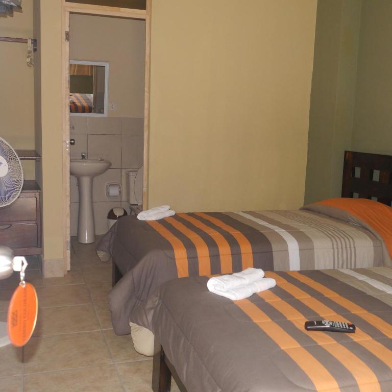 Postel nebo postele na pokoji v ubytování Hostal Tambo Colorado