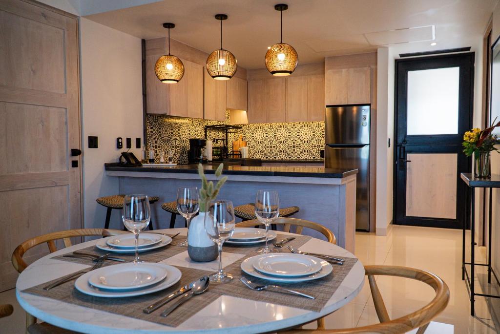 a table with plates and glasses on it in a kitchen at Flamboyan Hotel & Residences in San José del Cabo