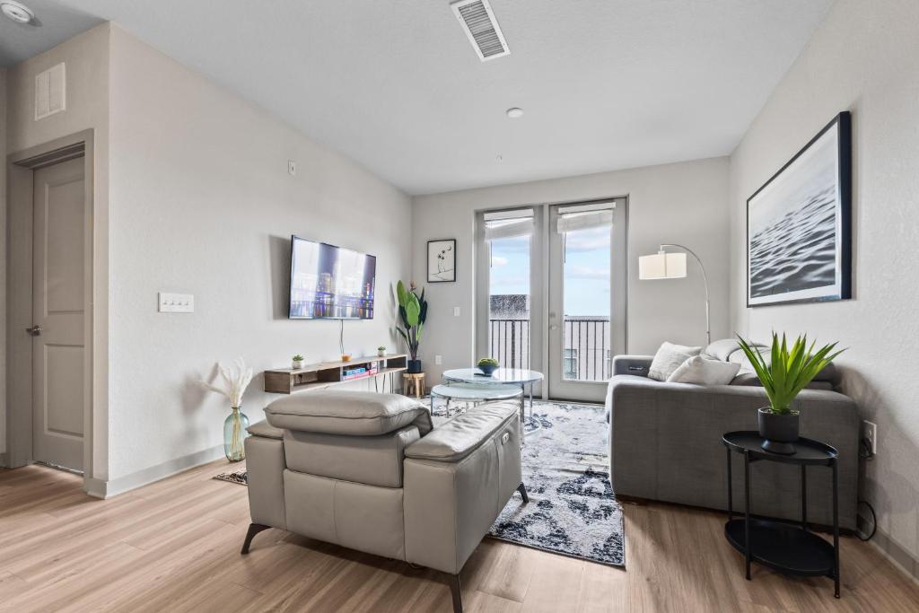 a living room with a couch and a table at Downtown St Pete 2 Bed Near Tropicana Field WIth Free Parking in St. Petersburg